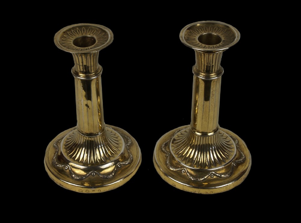 a pair of hallmarked 18th century english sterling silvergilt neoclassical candlesticks