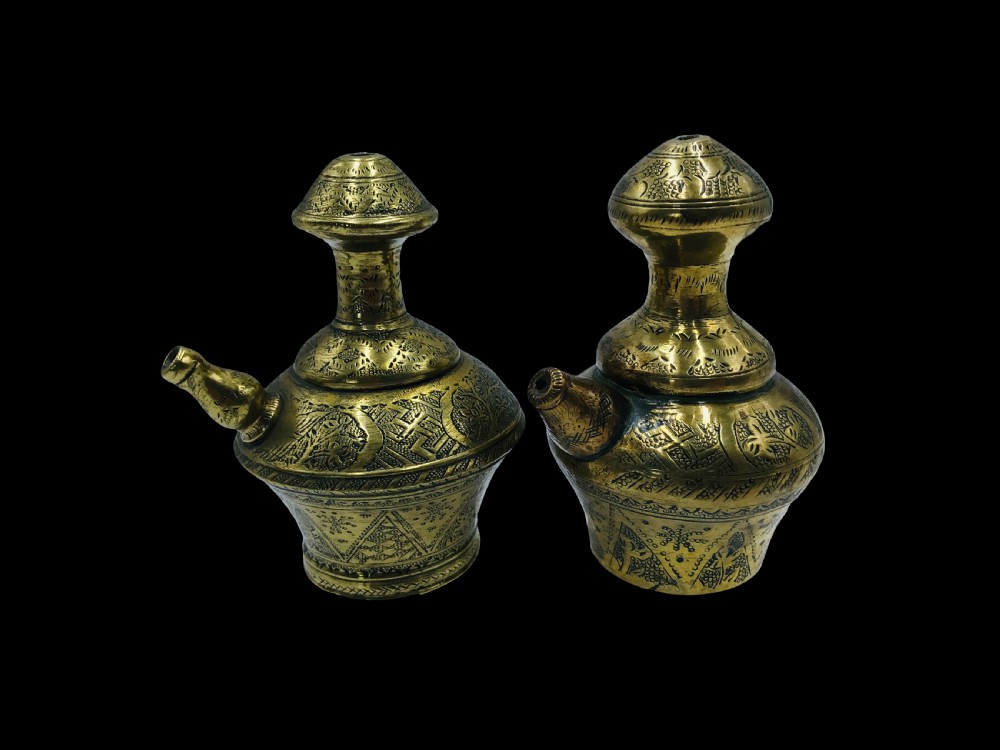 a matched pair of indonesian brass kindi kendi brass water vessels east java circa 1900