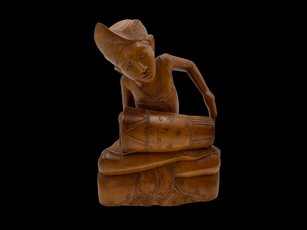 a finely carved wood 'drummer' figure bali indonesia early to mid 20th c